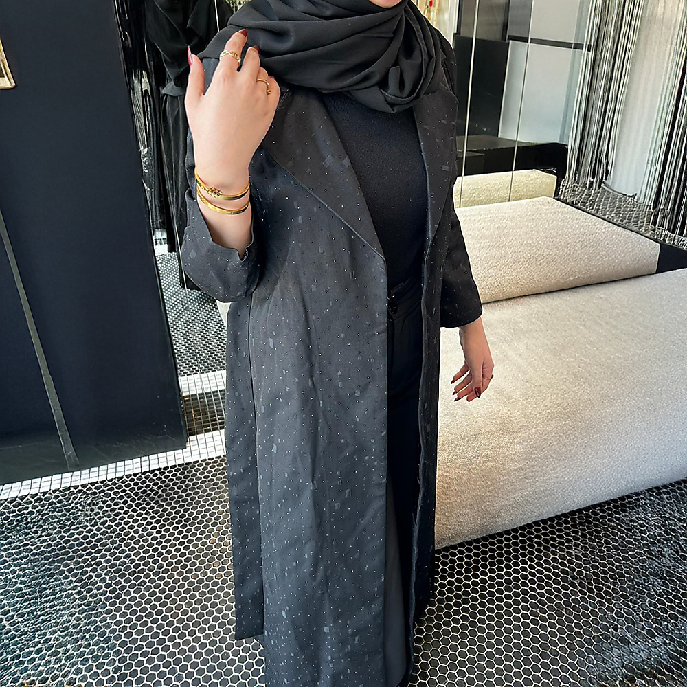 Coat-style design with a waist tie and double-faced pockets