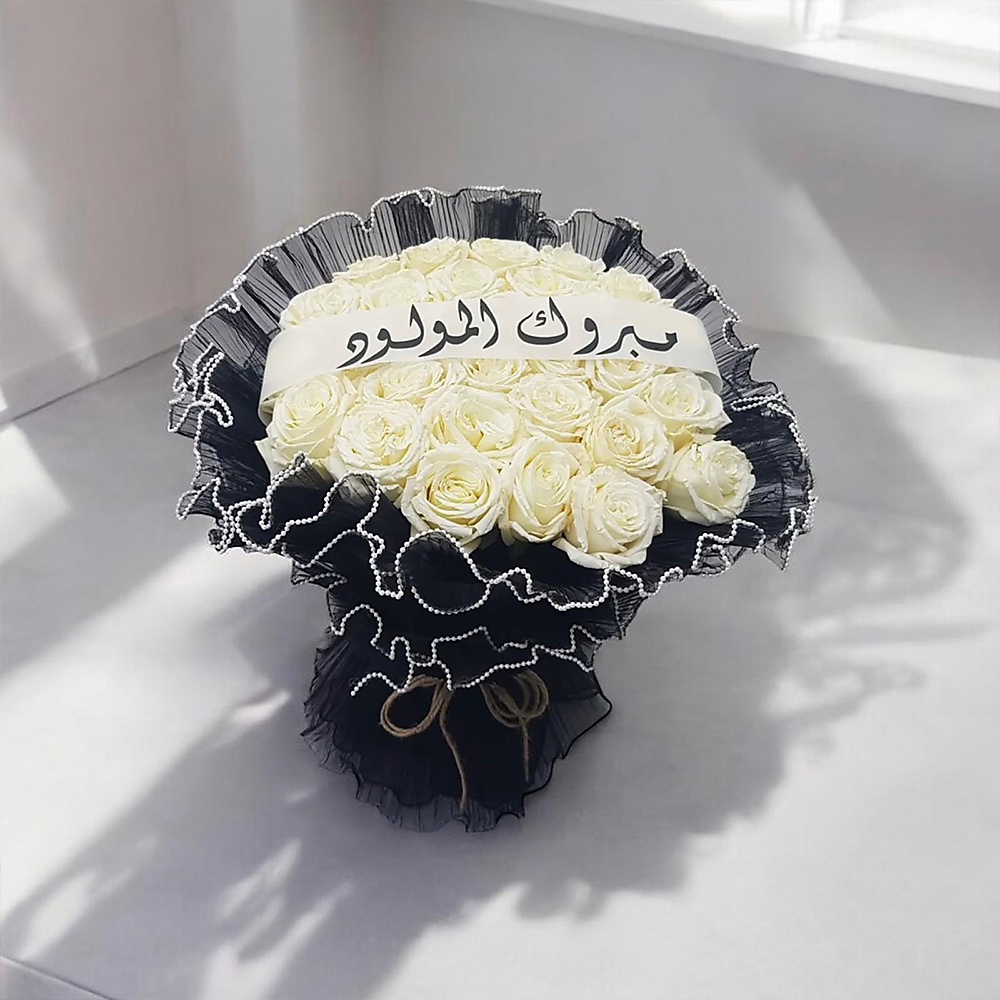 white roses bouquet wrapped in black fabric