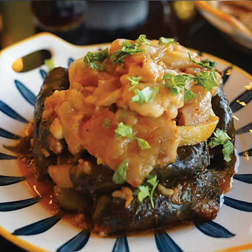 Knuckle Tagine with stuffed grape leaves