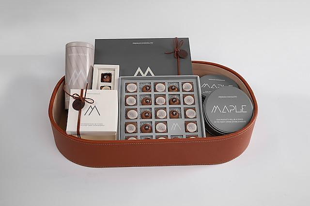 brown leather box with assorted chocolates