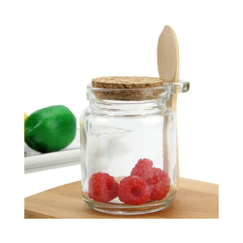 وعاء زجاج مع غطاء وملعقة خشب