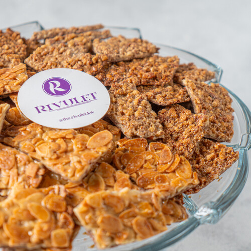 A tray of delicious peices of belgian with caramelized almond &pecan
